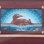 the Loon and Fish mural. Blue and brown patterns make up the loon and fish.