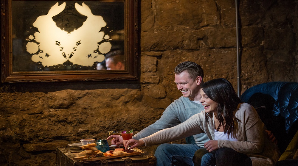 A couple at the Velveteen reaching for an appetizer. 