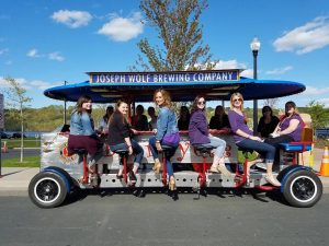 Many people enjoying the biercycle from Joseph Wolf's Brewing Company. 