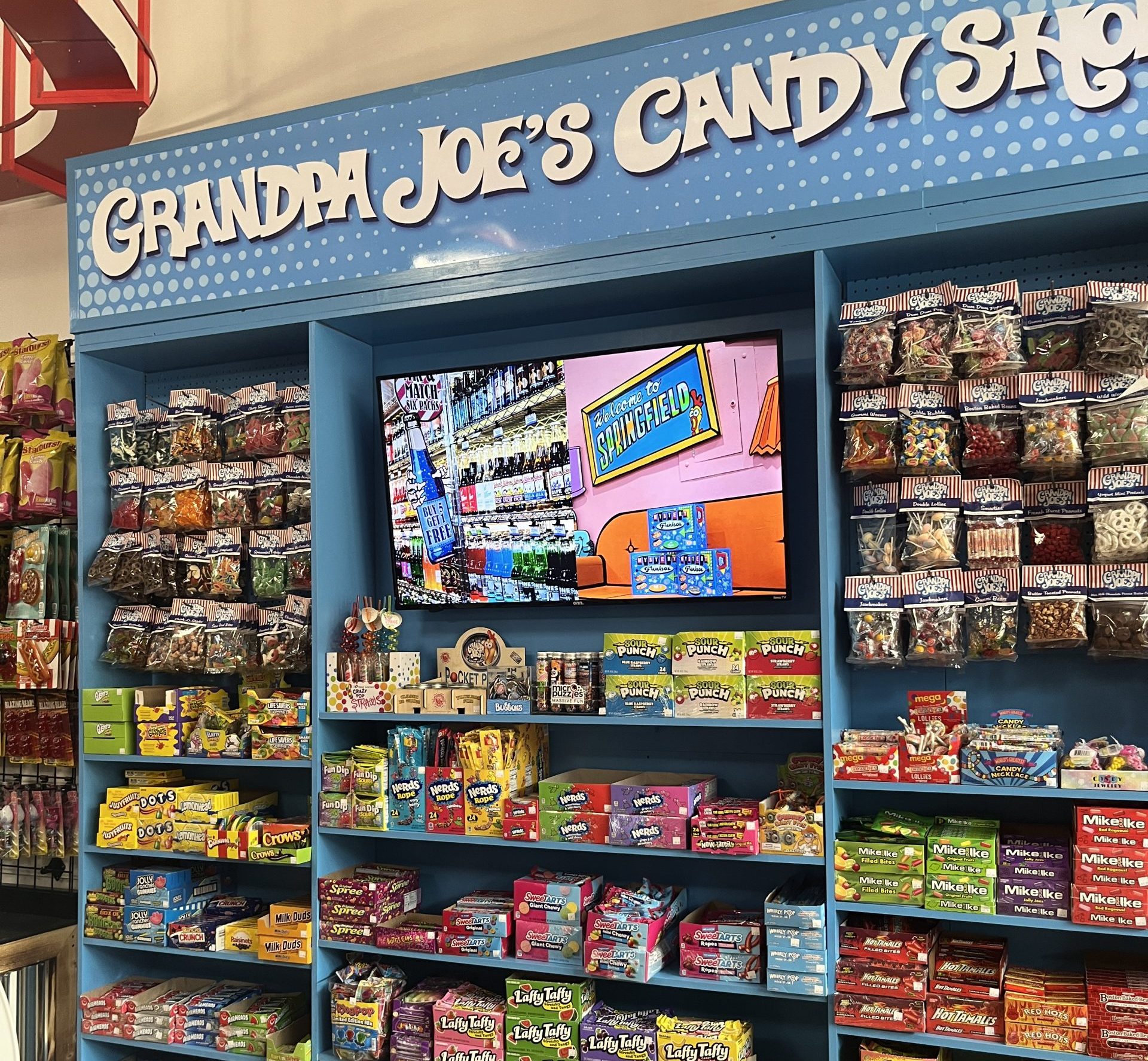 Grandpa Joe's Candy Shop Interior with blue shelves filled with candy.