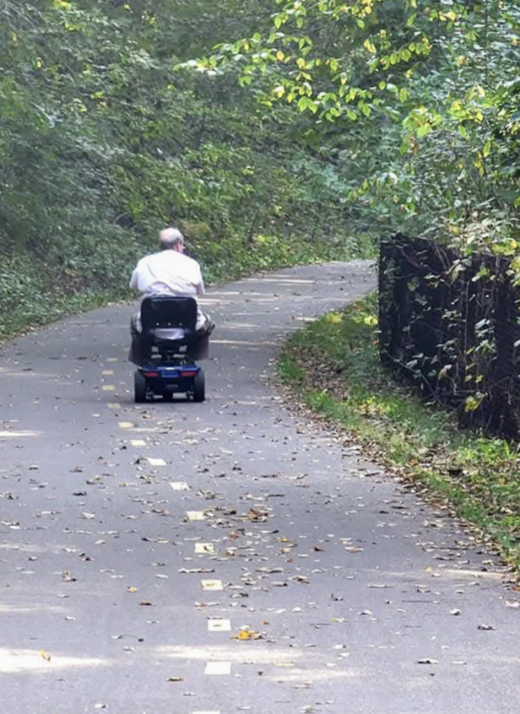 Man using accessible mobility device in Brown's creek trail Stillwater