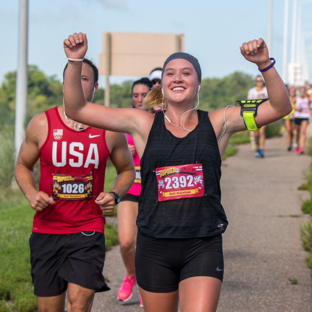 person running with their arms in the air triumphantly