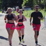 three people in matching colors running a race