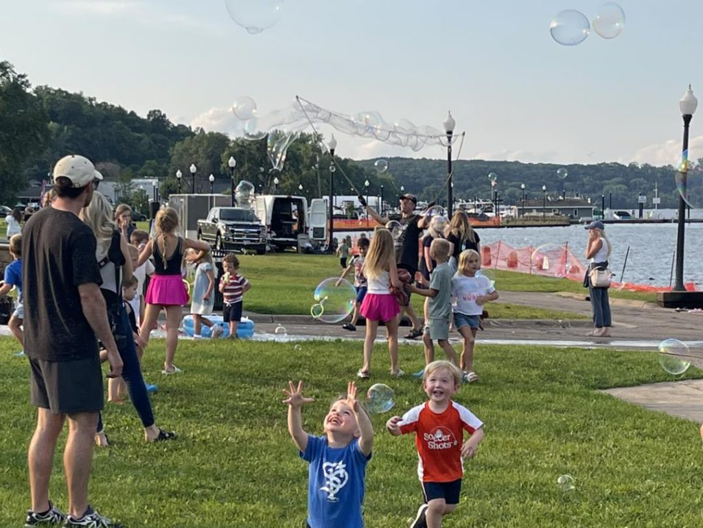 Children playing with bubbles outside